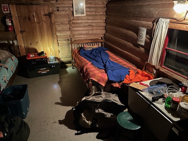 Cabin camping sleep gear and storage organized for a wet trip