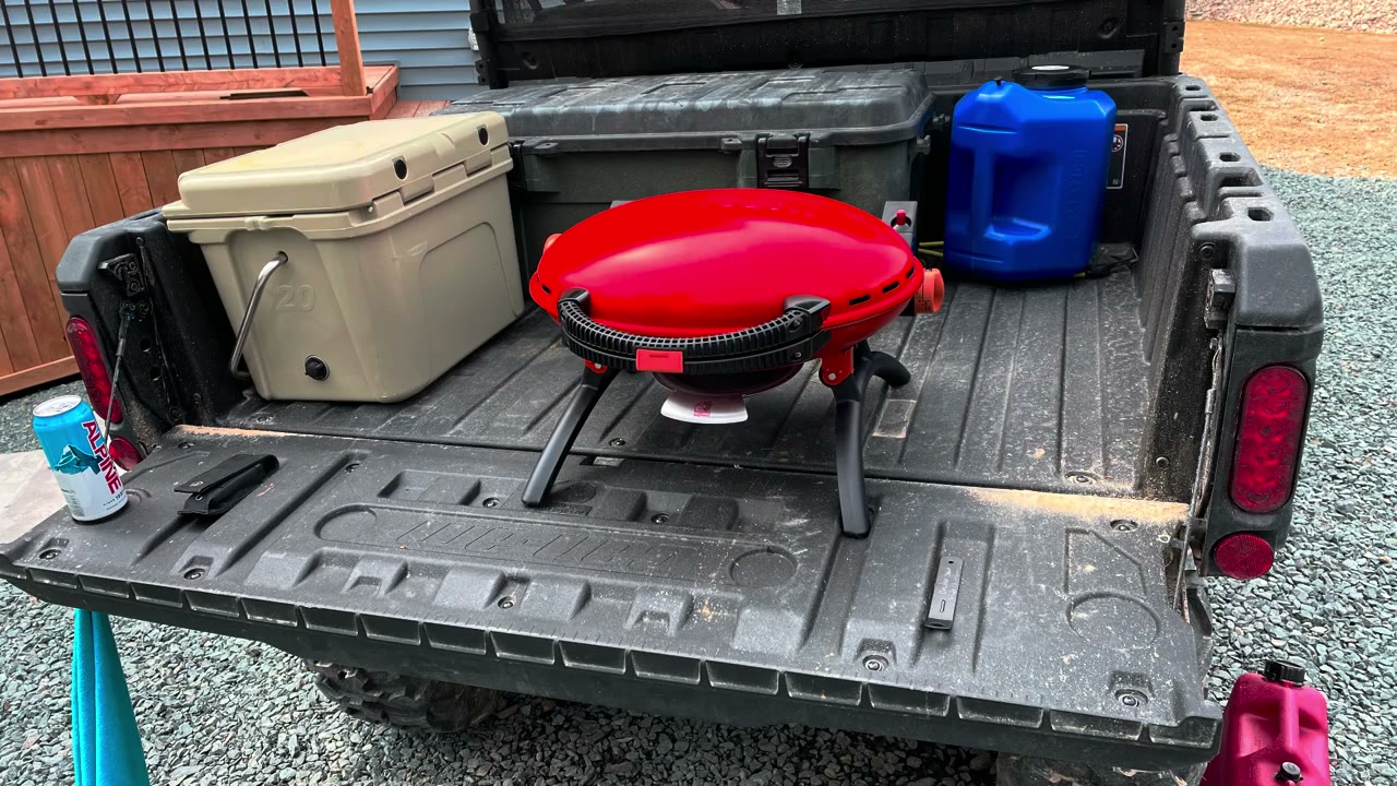 Can-Am Defender cargo bed loaded with camping gear and supplies