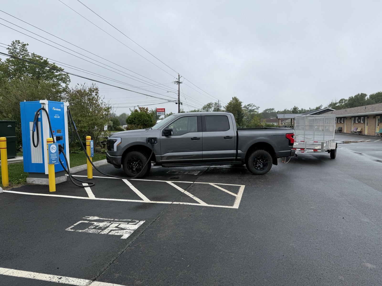 Ford F-150 Lightning and utility trailer at a Tatamagouche-area EV charging stop