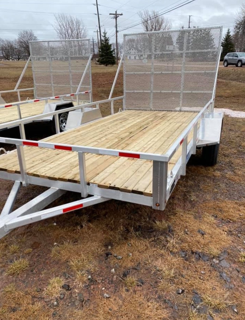 Open 6x12 aluminium utility trailer with tall mesh loading ramp